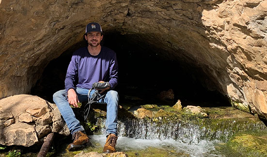 male hydrology student in the field